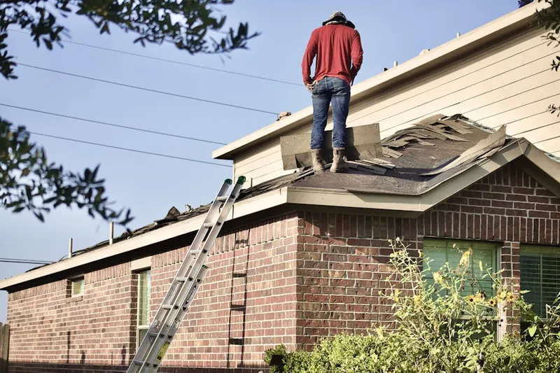 Professional roofer working on a residential roof in Devils Lake